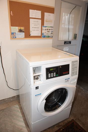A white washing machine with a digital display and control panel.